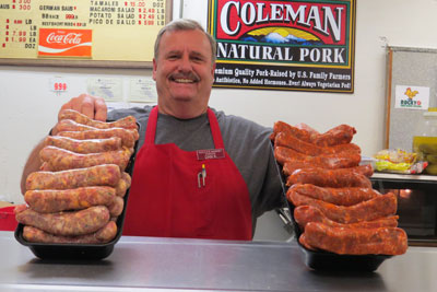 Rocca's Market butcher Dan Keith shows off his sausages. Photo by Marty Cheek